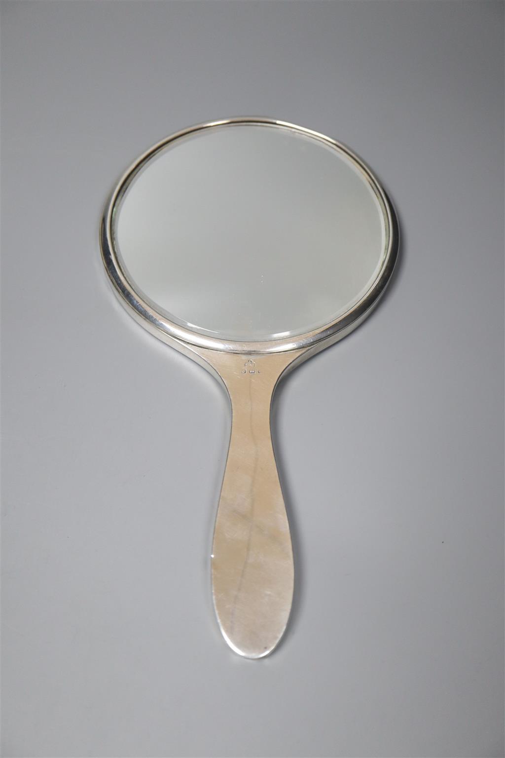 A 1920s engine turned silver mounted four piece mirror and brush set by Elkington & Co, Birmingham, 1925.